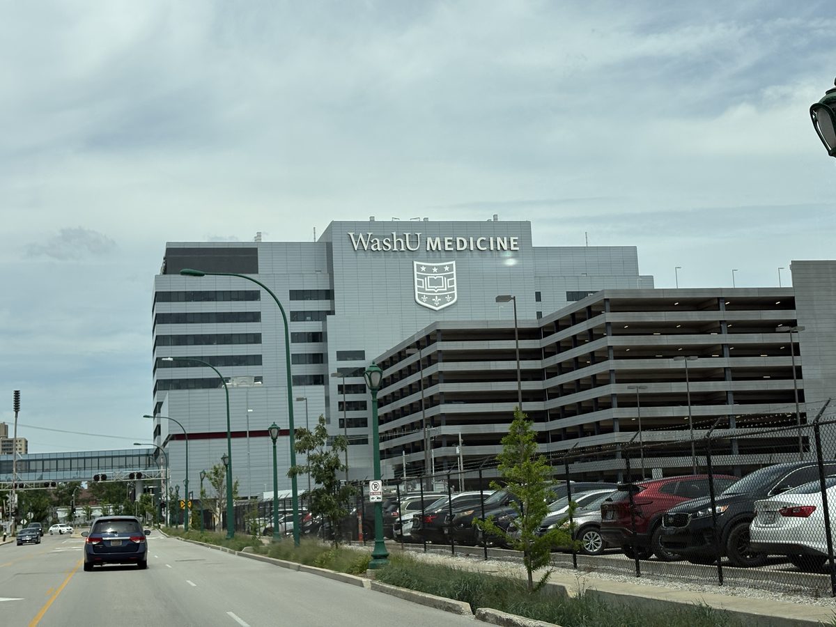 The only gas station within the Central West End St. Louis — Laclede Avenue corner, high-rise residential towers behind, illustrating the urban density of the CWE corridor near Forest Park