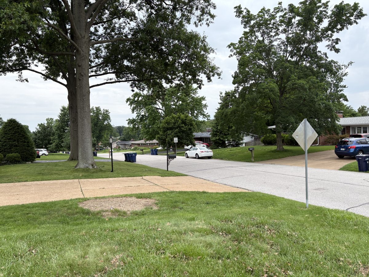 Crestwood St. Louis neighborhood — 1960s brick ranch on large corner lot, cul-de-sac street with mature oak canopy, 63126 South County residential character