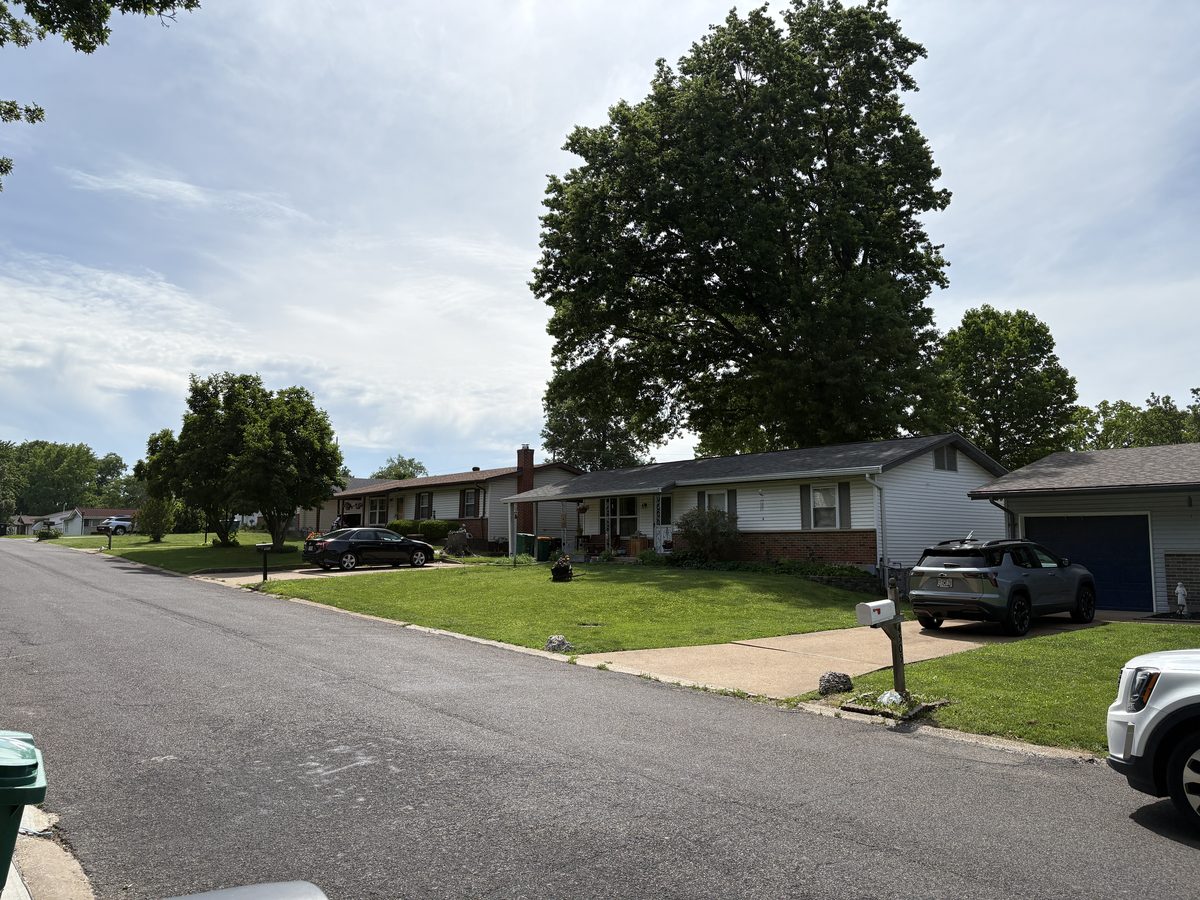 Oakville MO homes for sale — full brick 1960s ranch on deep-setback lot with attached garage, South County St. Louis 63129