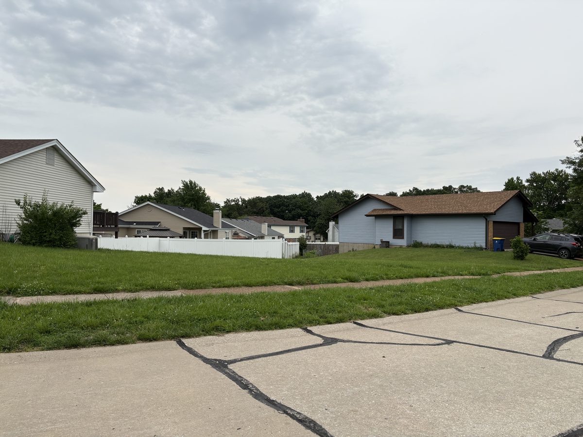 Oakville MO homes for sale — 1960s brick ranch on large wooded lot at Tall Oak Court, deep setback, mature tree canopy, quiet residential street in 63129 South County St. Louis