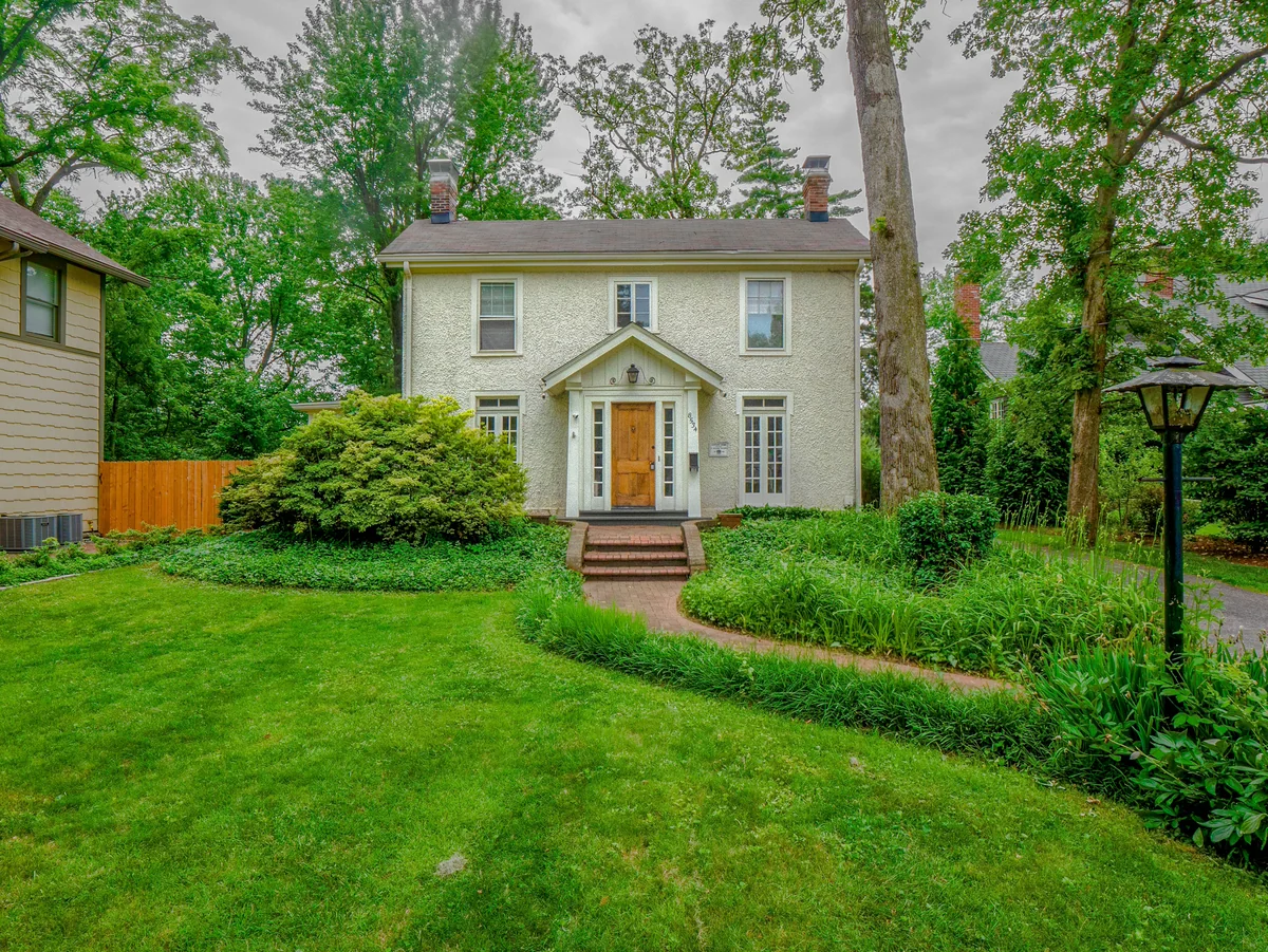 Webster Groves stucco colonial — mature landscaping