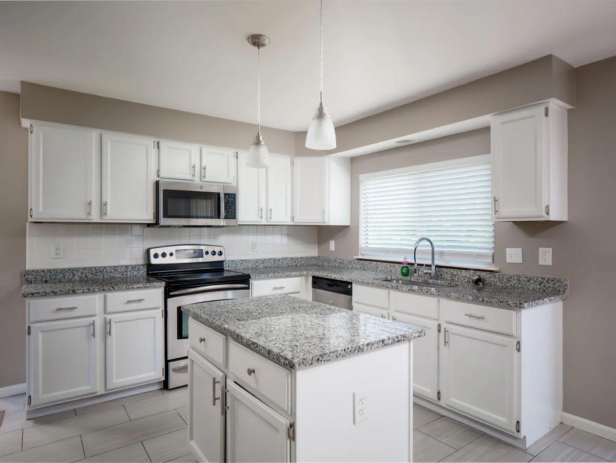 Open concept living — hardwood floors, kitchen view