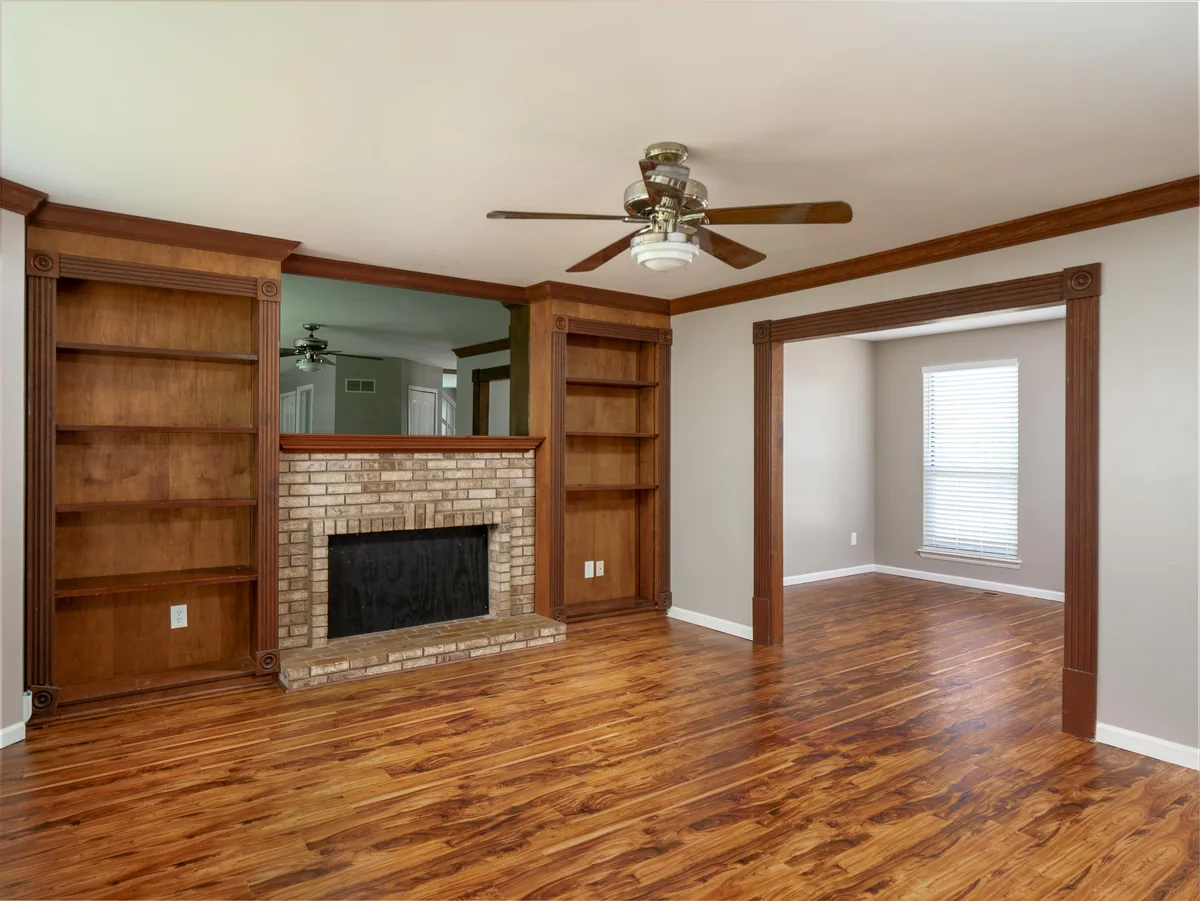 Living room — built-ins, brick fireplace, hardwood