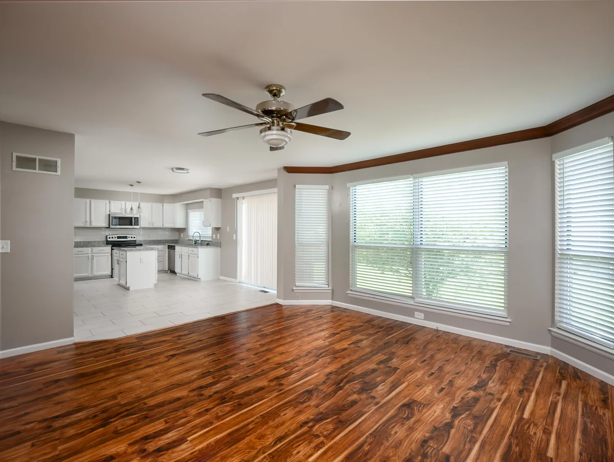Kitchen — white cabinets, granite island, pendant lighting