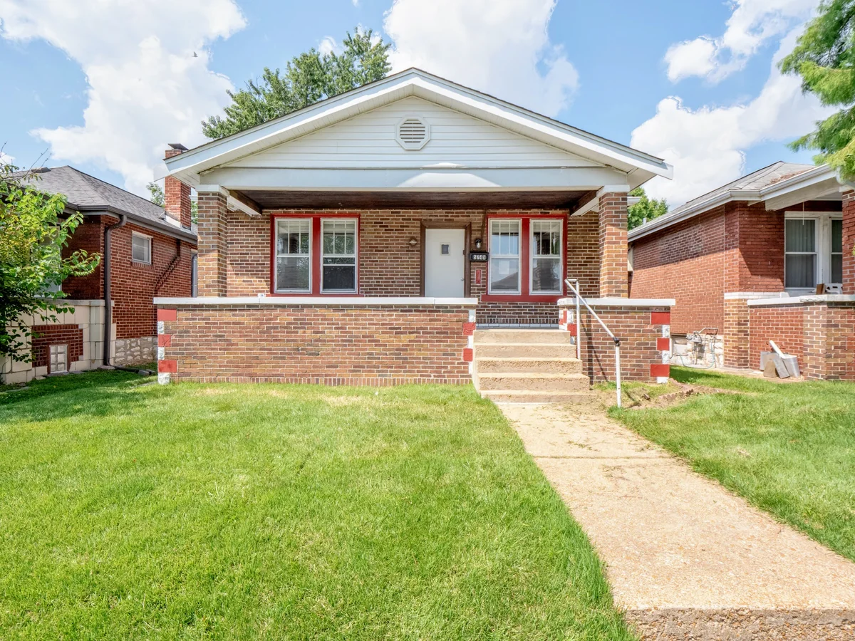 Princeton Heights St. Louis housing stock — brick bungalow with covered porch on tree-lined street