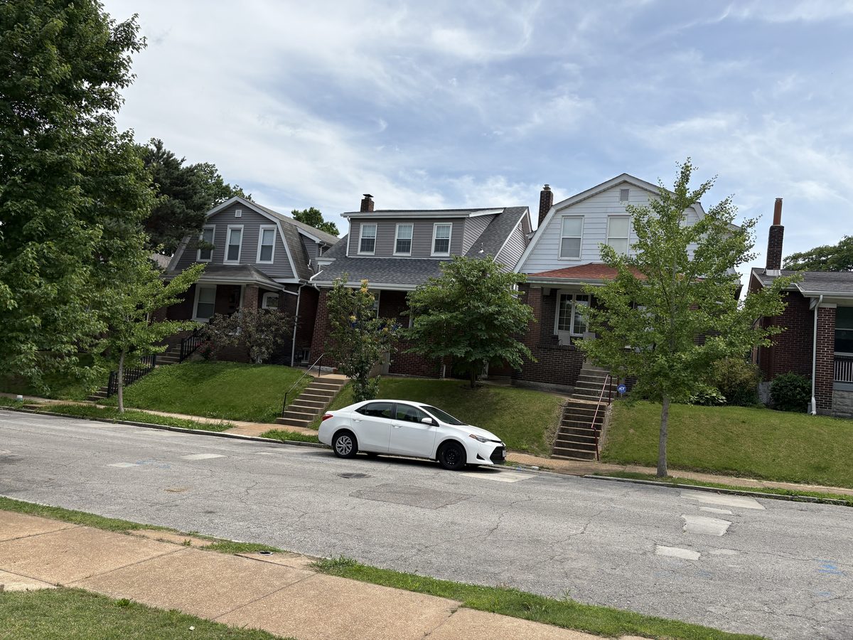 Southampton 63109 streetscape — attached brick bungalows with stone porch pillars, covered stoops, tight setback, South City St. Louis