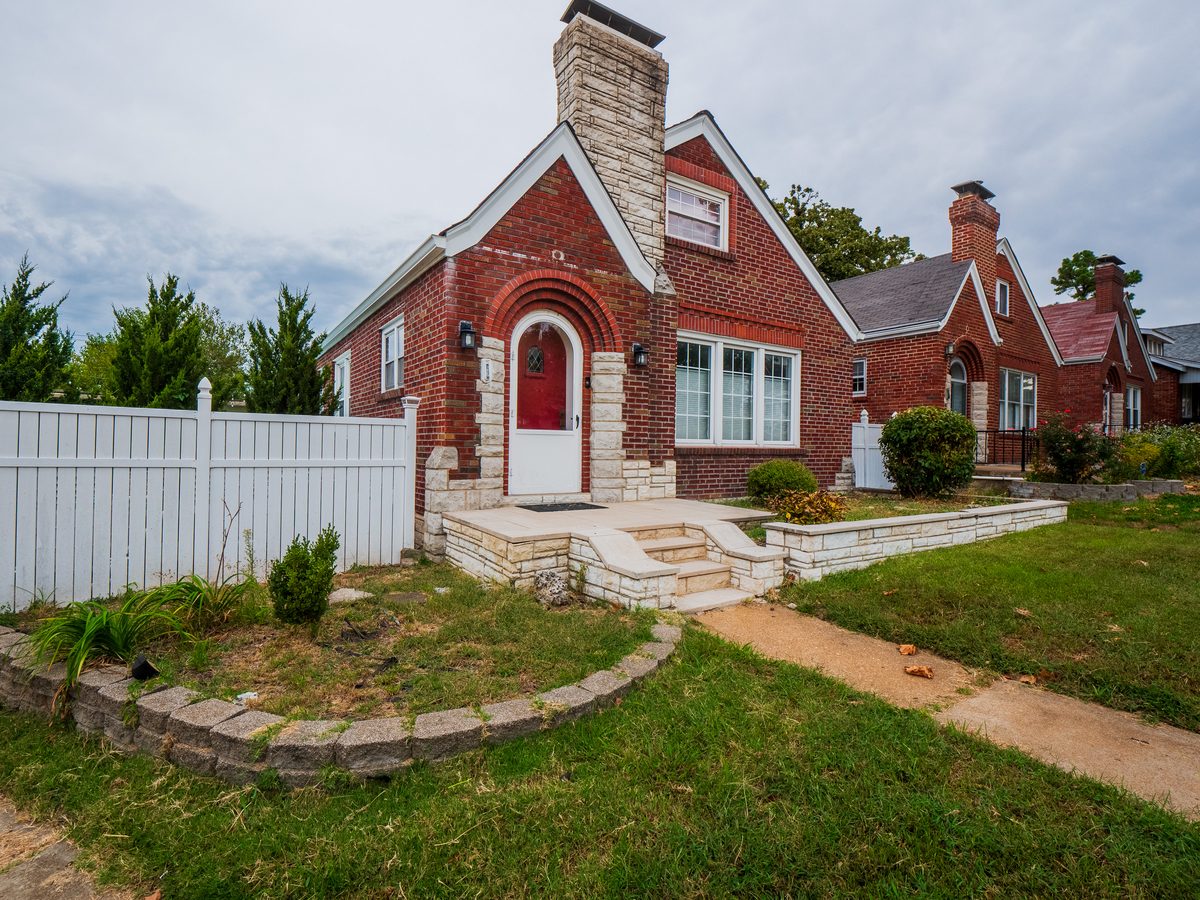 Southampton St. Louis homes for sale — 1.5-story brick Tudor bungalow with stone arch entry, stone chimney, and arched front door, representative of the 1930s housing stock in 63109 Southampton South City