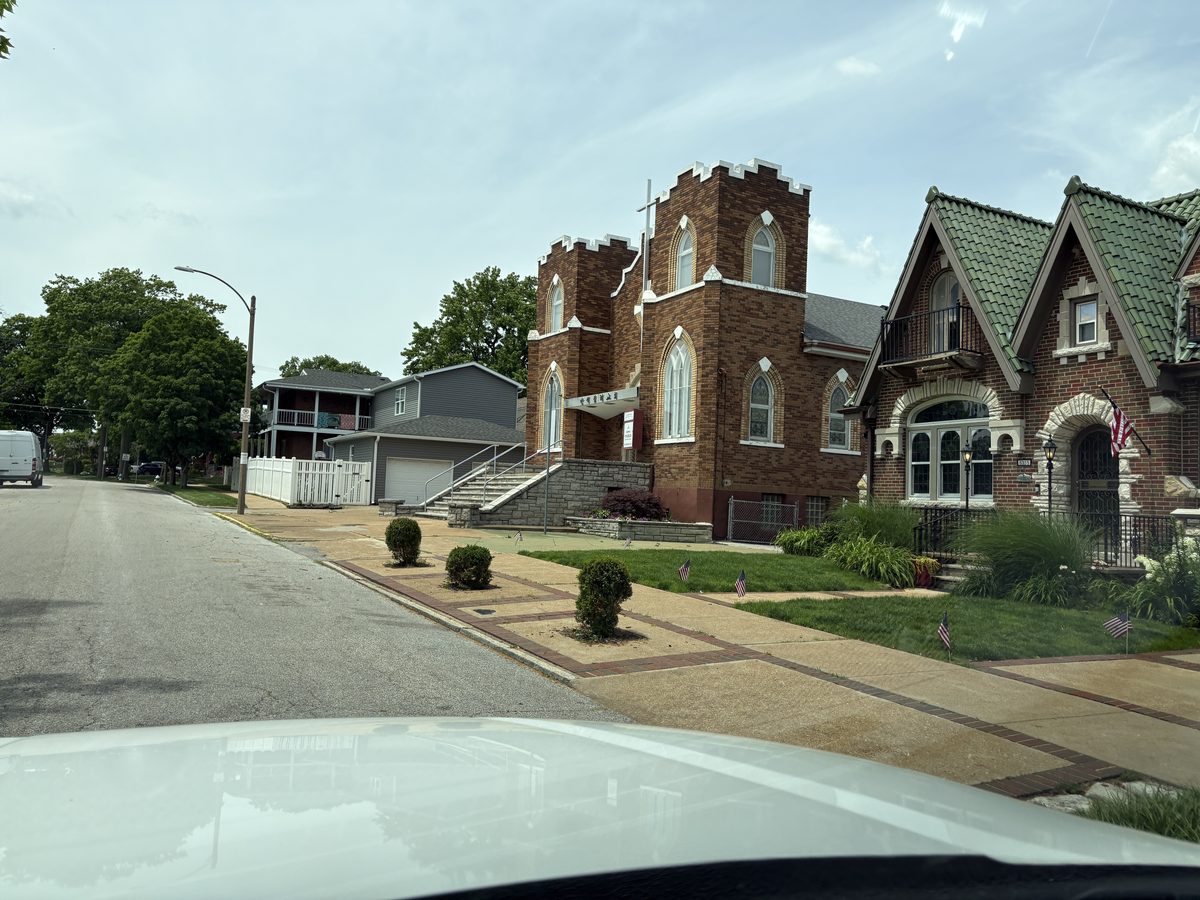 The Hill St. Louis neighborhood — Gothic brick church and ornate stone Victorian home on Botanical Avenue, late 1800s South City construction